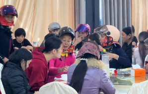 Why are these Chinese women wearing motorcycle helmets at banquets?